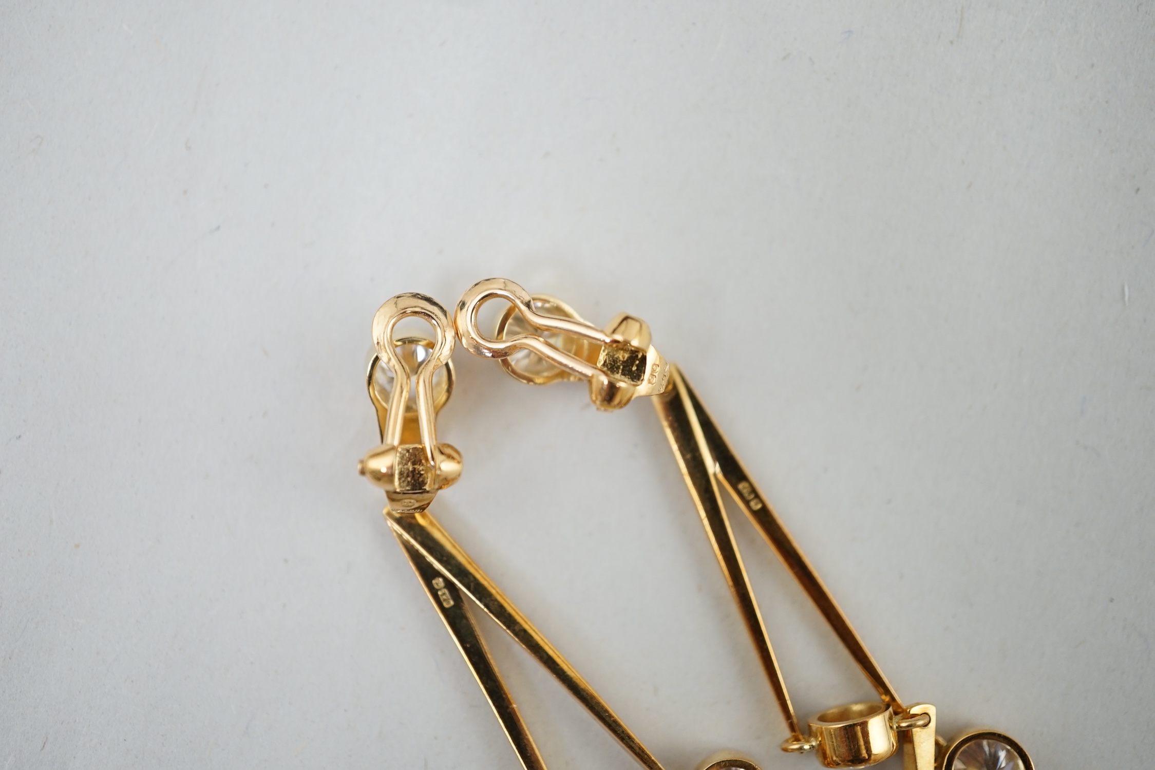 A pair of modern 18ct gold and three stone diamond set double drop ear clips